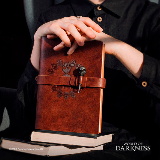 brown leather-bound journal with a strap closure and decorative skull engravement - Book Of Nod Journal World of Darkness Vampire: the Masquerade