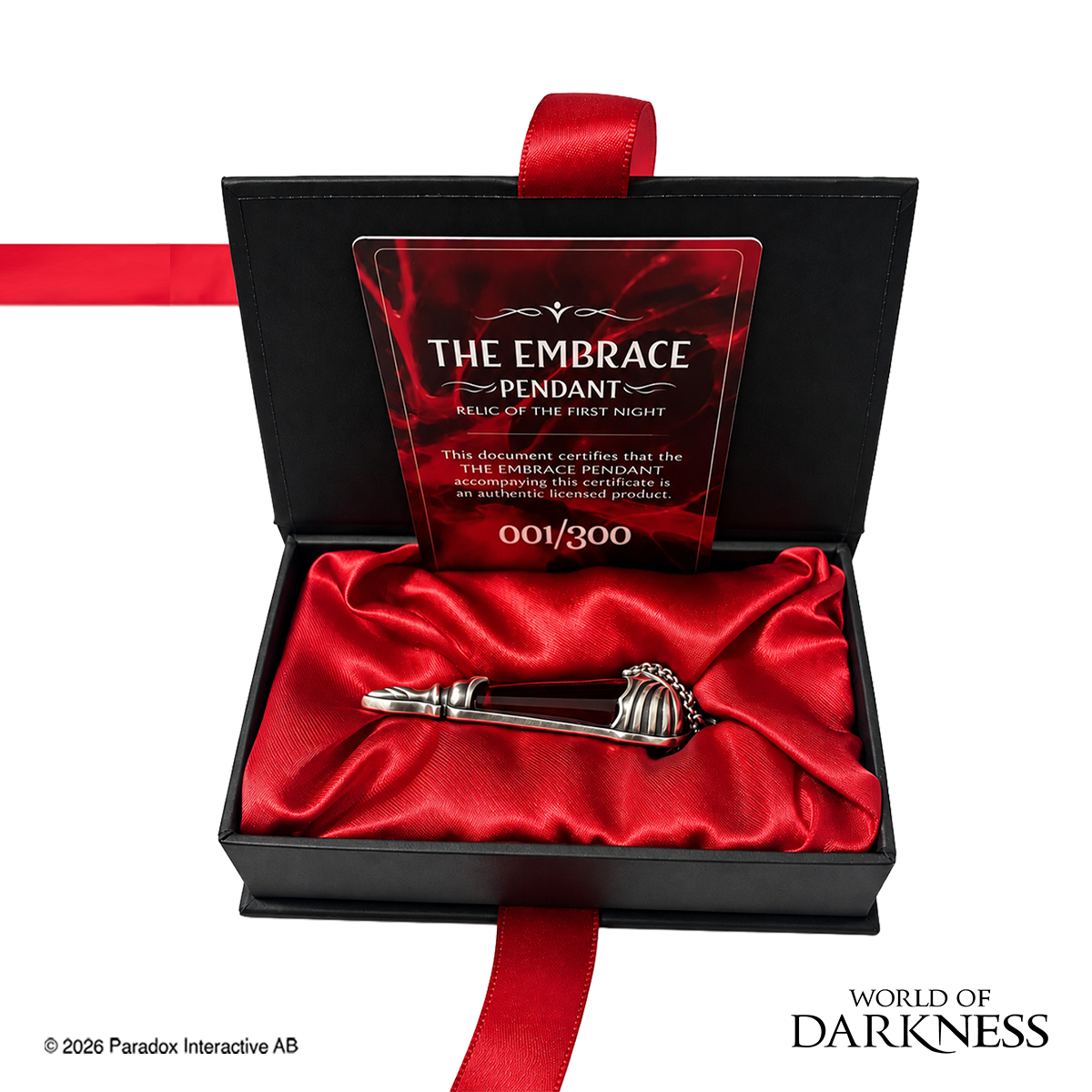 World of Darkness The Embrace Pendant, a limited edition gothic jewelry piece featuring a deep crimson red glass teardrop center set in an ornate silver-toned brass frame, displayed in a black presentation box with red satin lining alongside a numbered Certificate of Authenticity.
