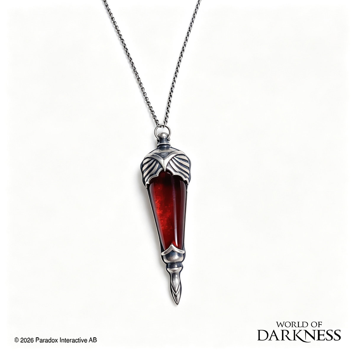 World of Darkness The Embrace Pendant, a limited edition gothic jewelry piece featuring a deep crimson red glass teardrop center set in an ornate silver-toned brass frame, displayed in a black presentation box with red satin lining alongside a numbered Certificate of Authenticity.
