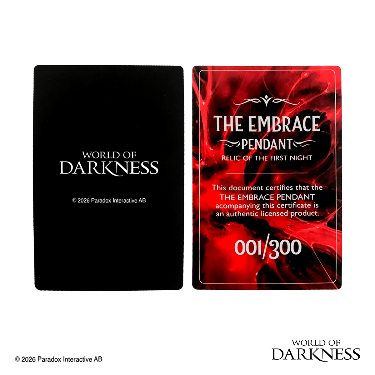 World of Darkness The Embrace Pendant, a limited edition gothic jewelry piece featuring a deep crimson red glass teardrop center set in an ornate silver-toned brass frame, displayed in a black presentation box with red satin lining alongside a numbered Certificate of Authenticity.

