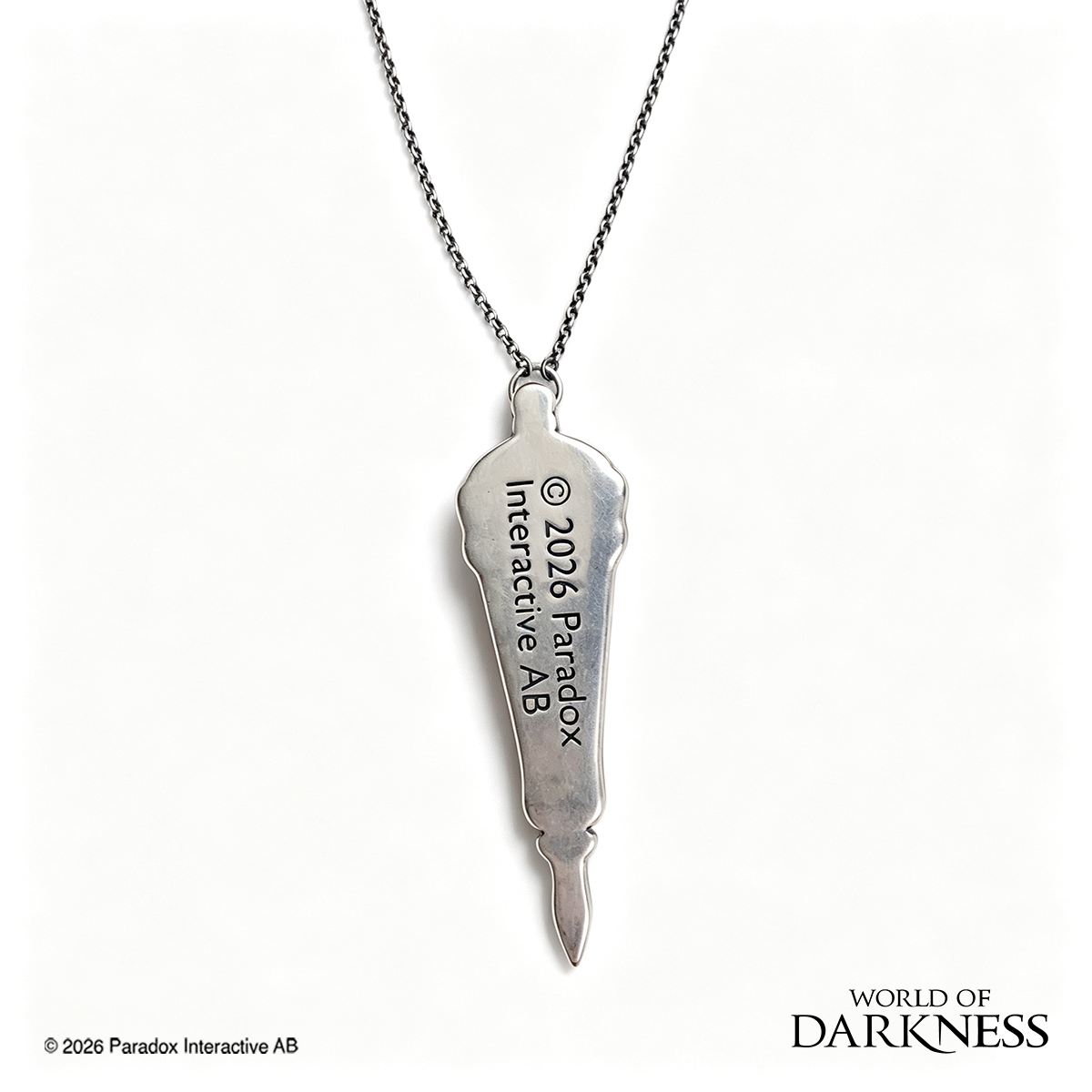 World of Darkness The Embrace Pendant, a limited edition gothic jewelry piece featuring a deep crimson red glass teardrop center set in an ornate silver-toned brass frame, displayed in a black presentation box with red satin lining alongside a numbered Certificate of Authenticity.