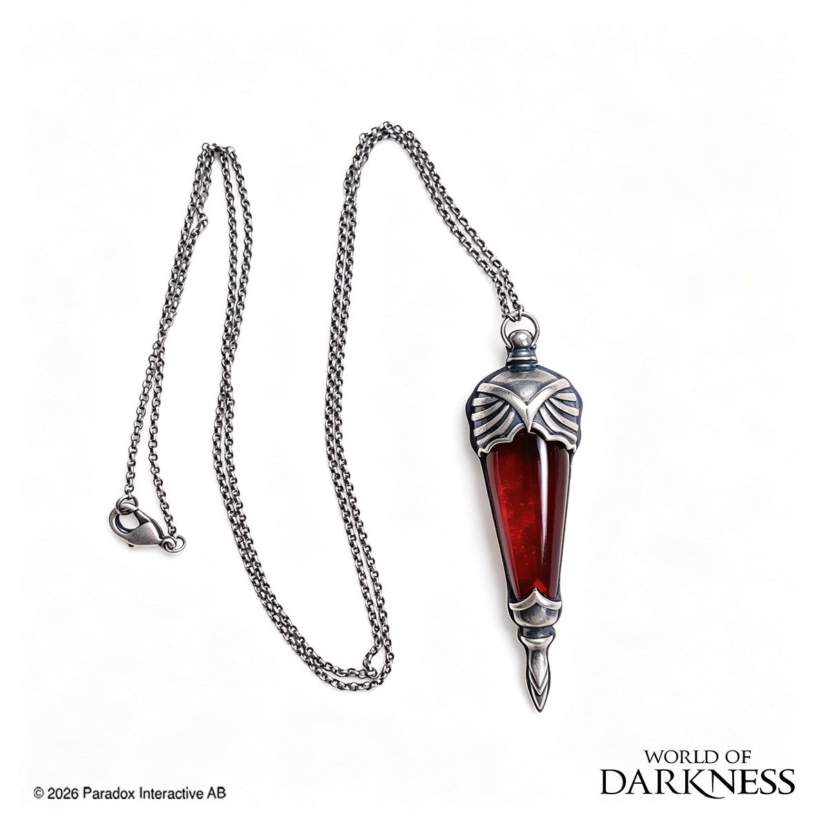 World of Darkness The Embrace Pendant, a limited edition gothic jewelry piece featuring a deep crimson red glass teardrop center set in an ornate silver-toned brass frame, displayed in a black presentation box with red satin lining alongside a numbered Certificate of Authenticity.